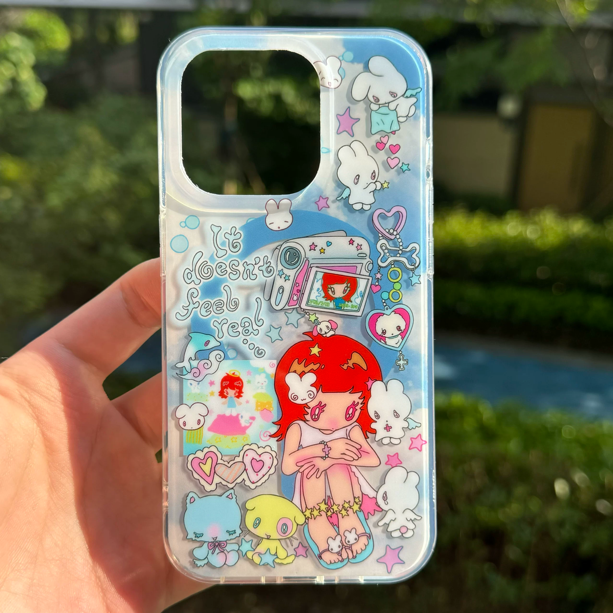 Niaoniao Dream theme kawaii iPhone case held in hand showing full illustration